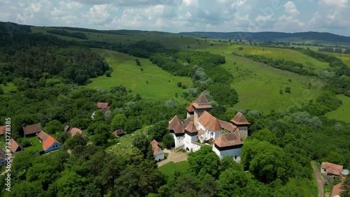 Beautiful and traditional Viscri Village. Viscri is only one of the Saxon villages of Transylvania. View of his main attractions, The Fortified Church and cemetery. Drone spinning around the church. photo