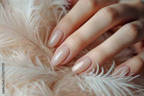 Womans Hands With Manicure and Feather