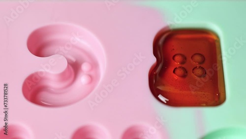 Pour sucking candies into molds. Lollipops.