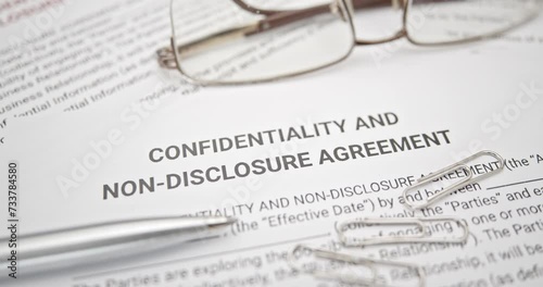 Blue pen on a confidentiality and non-disclosure agreement form. A confidentiality and non-disclosure agreement form safeguards sensitive information, outlining obligations, exceptions, and remedies. photo