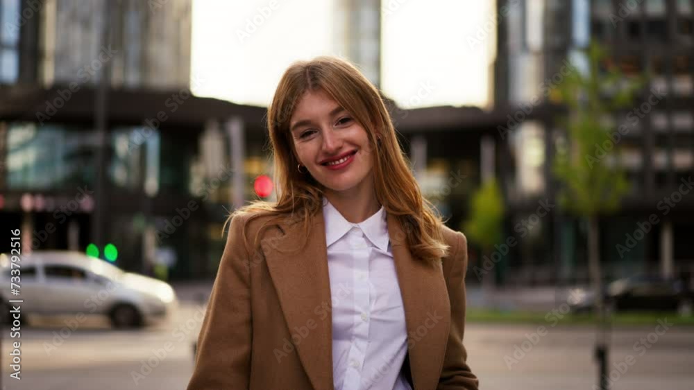 Portrait gorgeous realtor strolling street and looking camera with smile Portrait gorgeous realtor strolling street and looking camera with smile