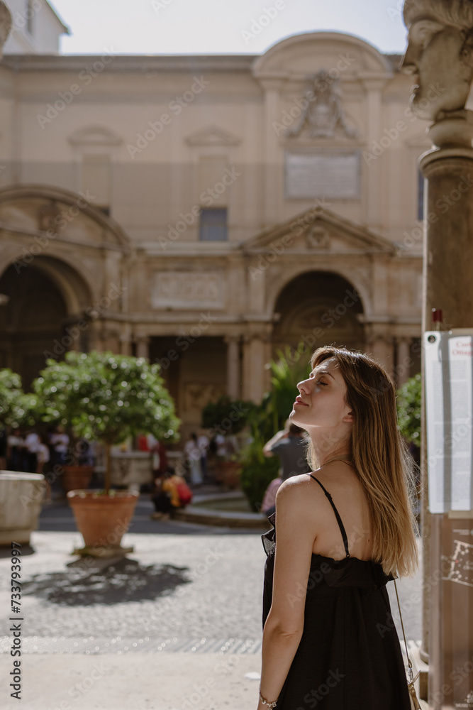 Young beautiful woman in historical site. She is posing in the sun.