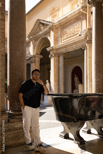 Young tourist man visits Vatican Museum.