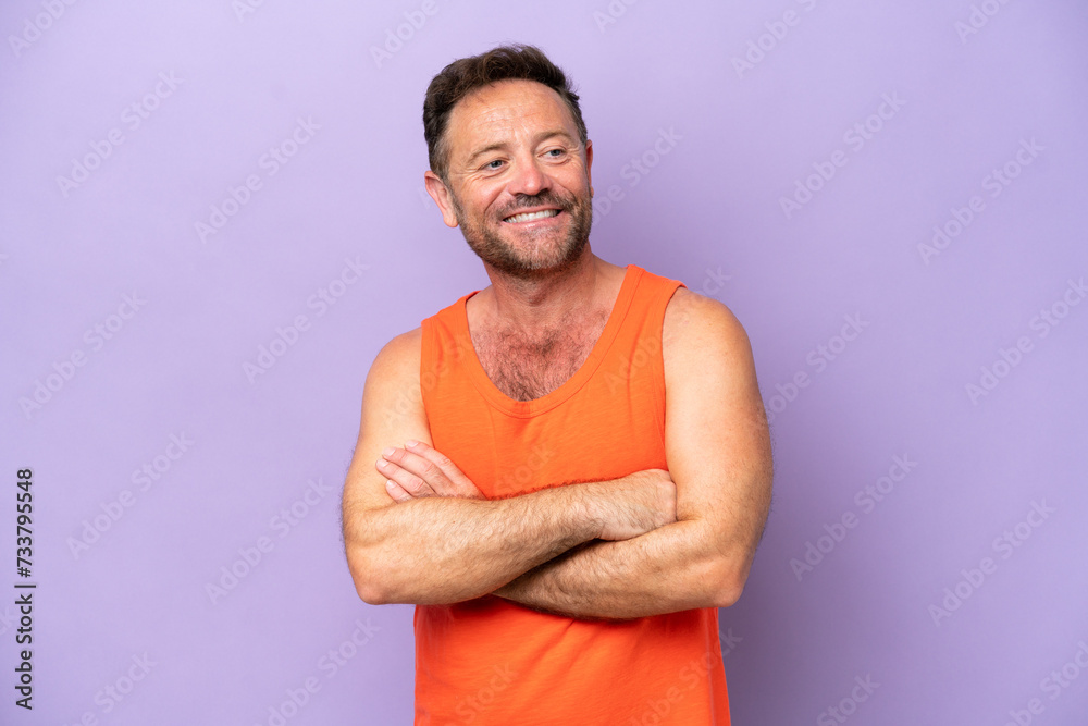 Middle age caucasian man isolated on purple background with arms crossed and looking forward Middle age caucasian man isolated on purple background with arms crossed and looking forward