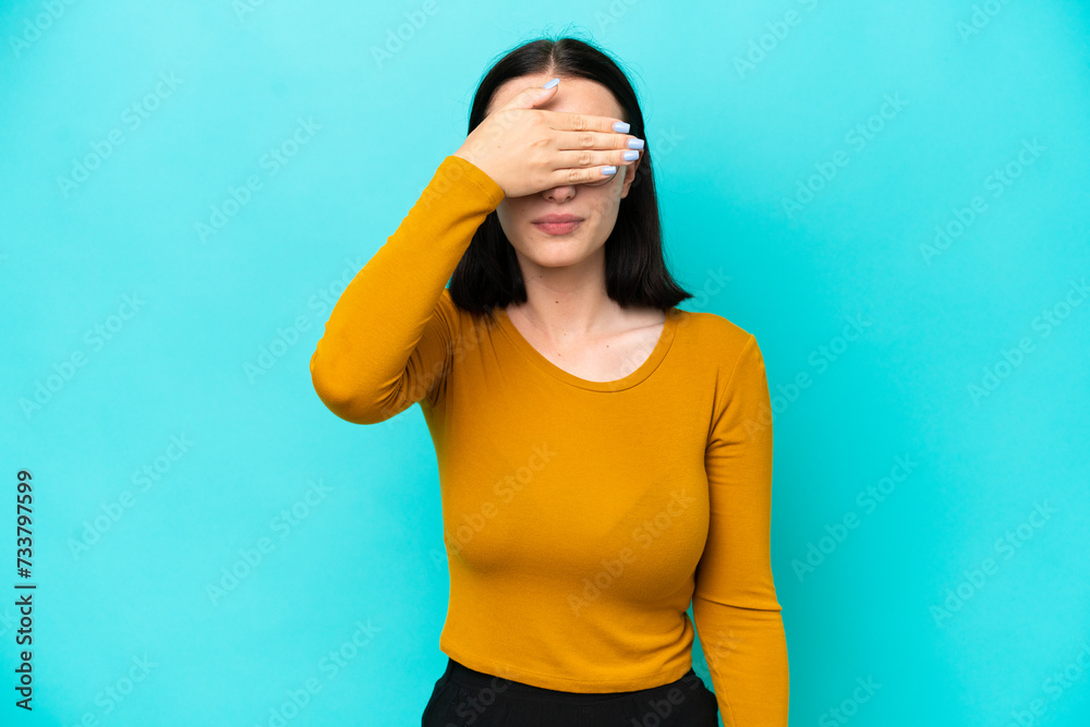 Young caucasian woman isolated on blue background covering eyes by hands. Do not want to see something Young caucasian woman isolated on blue background covering eyes by hands. Do not want to see something