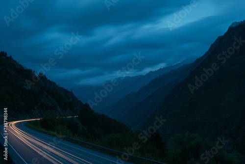 white and red traces of light from moving cars on highway at night, mountain landscape, fast moving