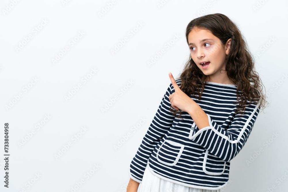 Little caucasian girl isolated on white background surprised and pointing side Little caucasian girl isolated on white background surprised and pointing side