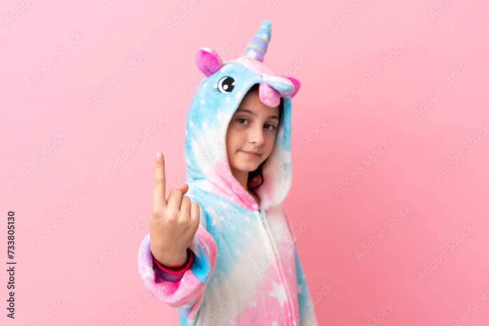 Little caucasian woman wearing a unicorn pajama isolated on pink background doing coming gesture Little caucasian woman wearing a unicorn pajama isolated on pink background doing coming gesture