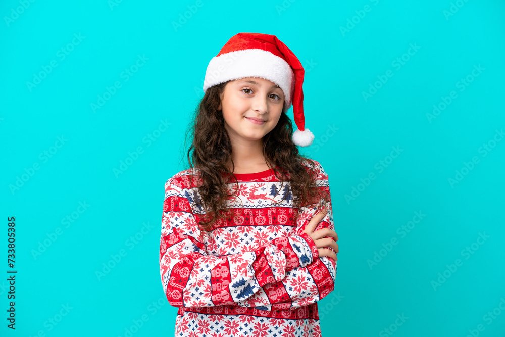 Little caucasian with christmas hat isolated on blue background smiling a lot Little caucasian with christmas hat isolated on blue background smiling a lot
