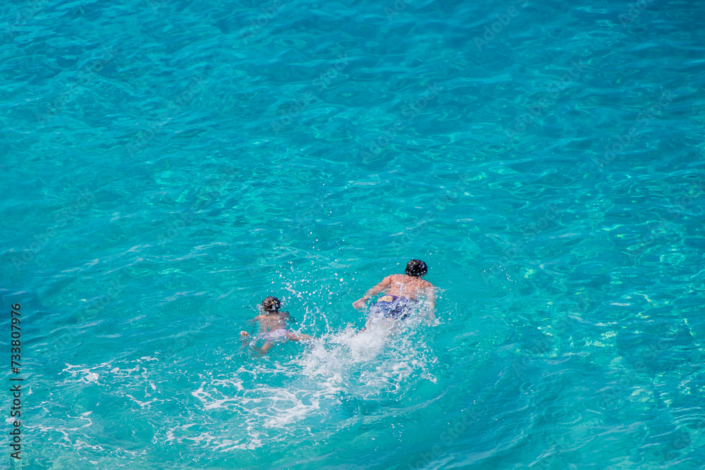 Kids are swimming at Kaputas Beach in Turkey