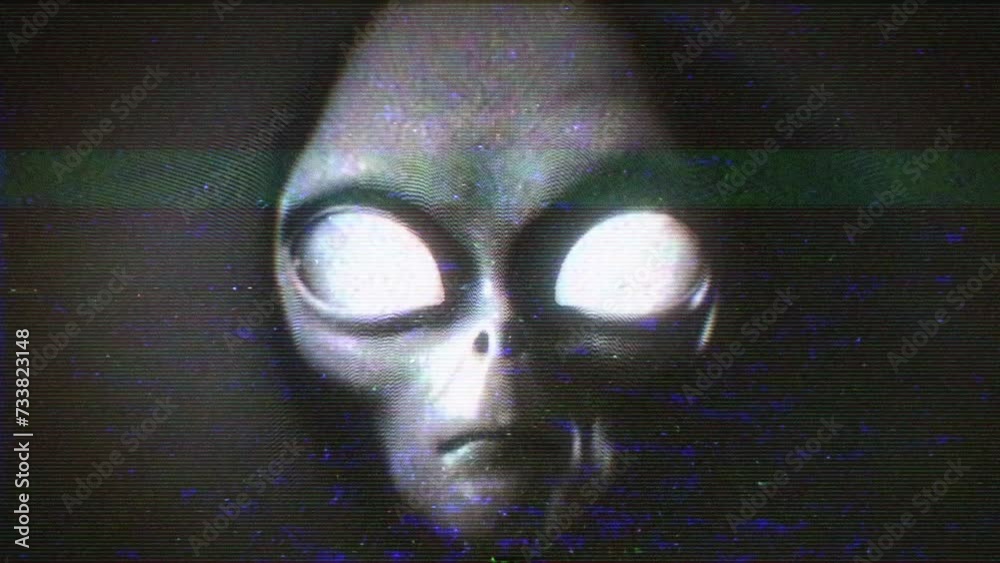 An Alien Grey face emerges from a hypnotic white noise static signal