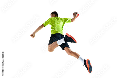 Competitive and concentrated young guy, handball player in motion during game, training against white studio background. Concept of professional sport, tournament, competition © master1305