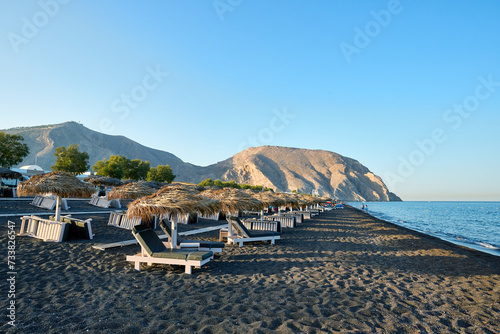 Fototapeta Naklejka Na Ścianę i Meble -  Perivolos beach is a characteristic beach of black sand and small dark pebbles, located in the southern part of the island of Santorini. Greek Islands, Santorini, European Vacation.