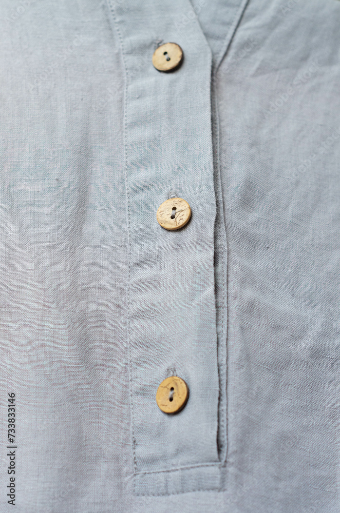 Close up coconut buttons on grey linen dress Close up coconut buttons on grey linen dress