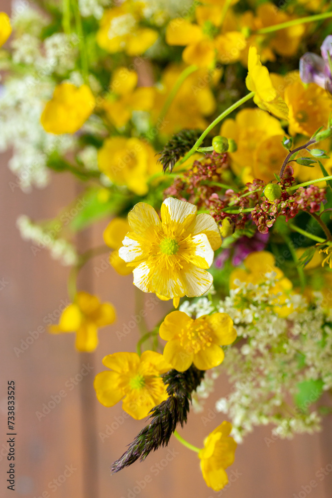 Small yellow wild flowers close up in meadow bouquet, mix of summer herbs and grass, floral vertical photo Small yellow wild flowers close up in meadow bouquet, mix of summer herbs and grass, floral vertical photo