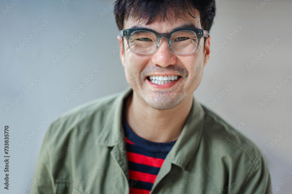 adult asian man.young male person wear eye glasses.posing smiling laughing look excited surprised thinking positive happy people.empty space for text advertising.grey background.attractive fashion adult asian man.young male person wear eye glasses.posing smiling laughing look excited surprised thinking positive happy people.empty space for text advertising.grey background.attractive fashion