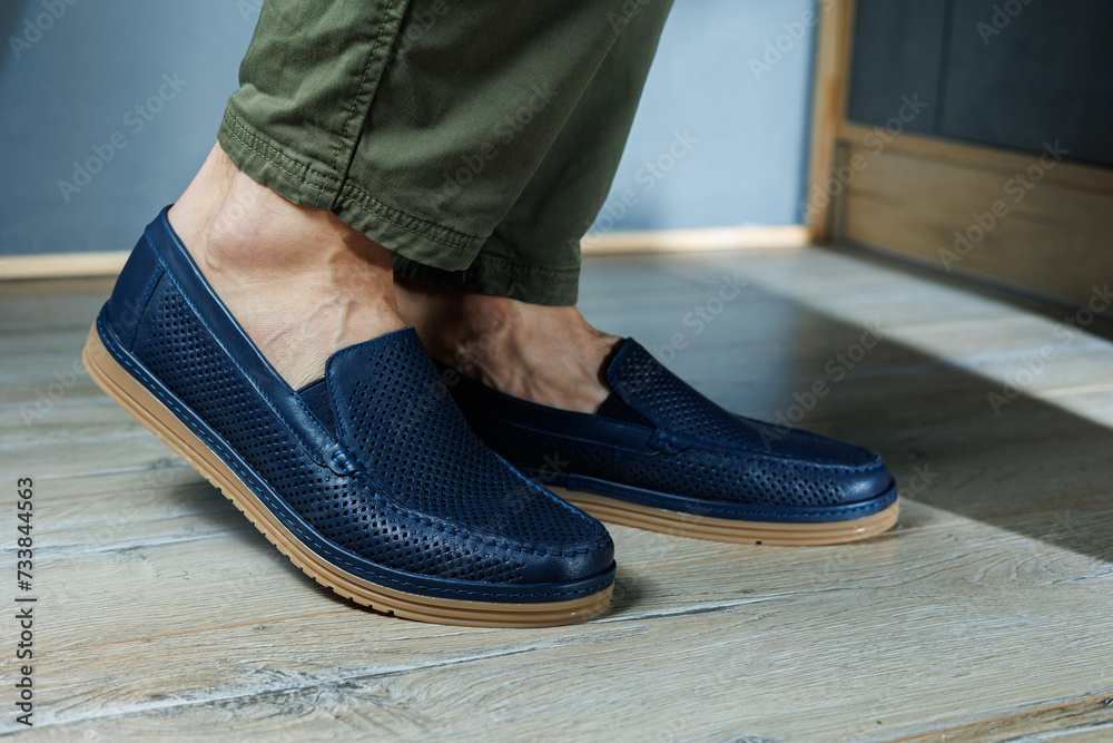 Male legs in blue leather shoes. Men's classic shoes. Male legs in blue leather shoes. Men's classic shoes.
