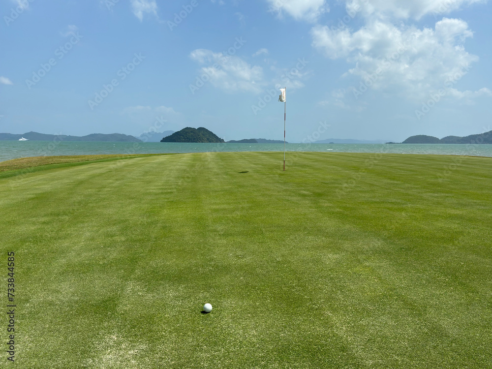 Green green golf course against the backdrop of the ocean. Playing golf and beautiful landscape Green green golf course against the backdrop of the ocean. Playing golf and beautiful landscape