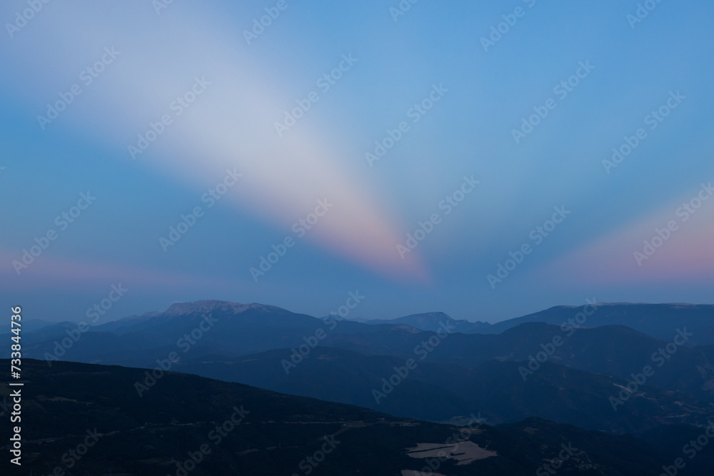 Sunset with anticrepuscular rays in the Sierra del Cadi, Pyrenees, Spain