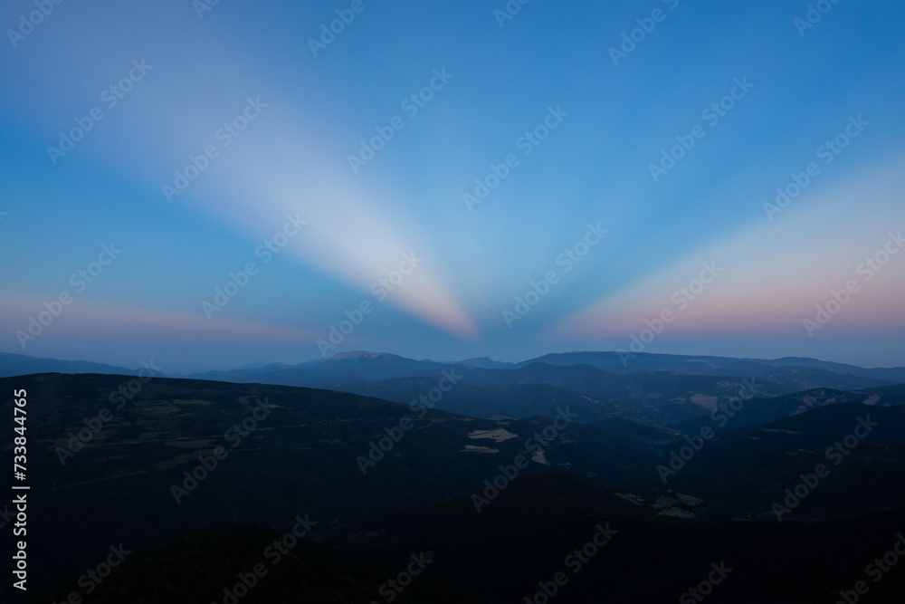 Sunset with anticrepuscular rays in the Sierra del Cadi, Pyrenees, Spain