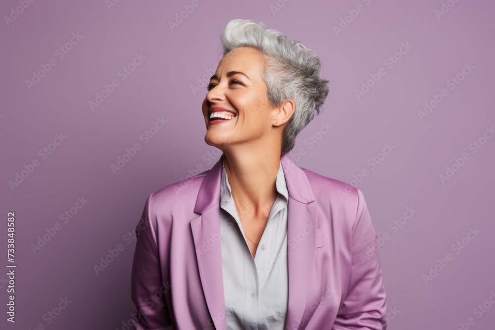 Portrait of a smiling senior businesswoman looking away over purple background Portrait of a smiling senior businesswoman looking away over purple background