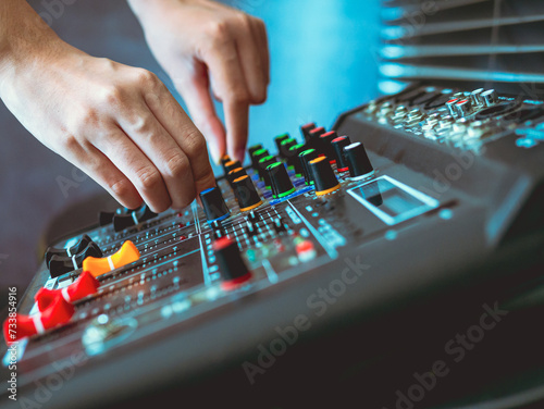 Close-up of sound engineer hands adjusting control sound mixer in recording, broadcasting studio,Sound mixer. Professional audio mixing console, buttons, faders and sliders. sound check.