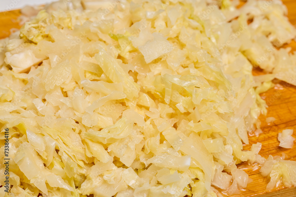 Sauerkraut on a wooden chopper ready to be cooked.