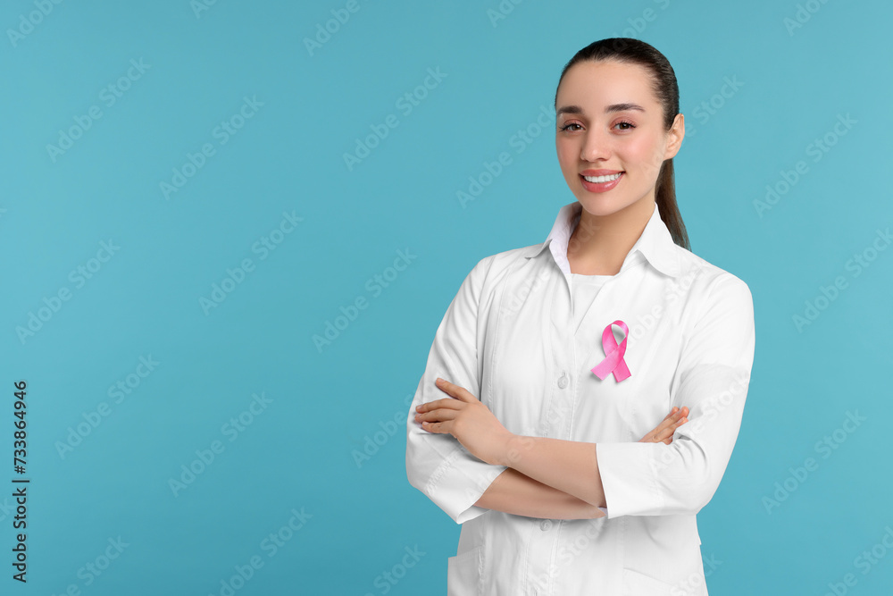 Mammologist with pink ribbon on light blue background, space for text. Breast cancer awareness Mammologist with pink ribbon on light blue background, space for text. Breast cancer awareness