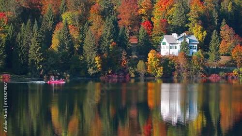 Riding on a motor boat on Altausseer lake. Superb autumn view of Austrian Alps. Calm morning scene of Altaussee village, Austria. Traveling concept background. Full HD video (High Definition)..