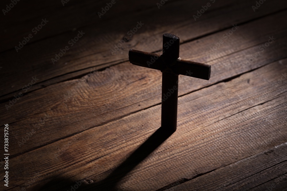 Christian wooden cross on wooden table background