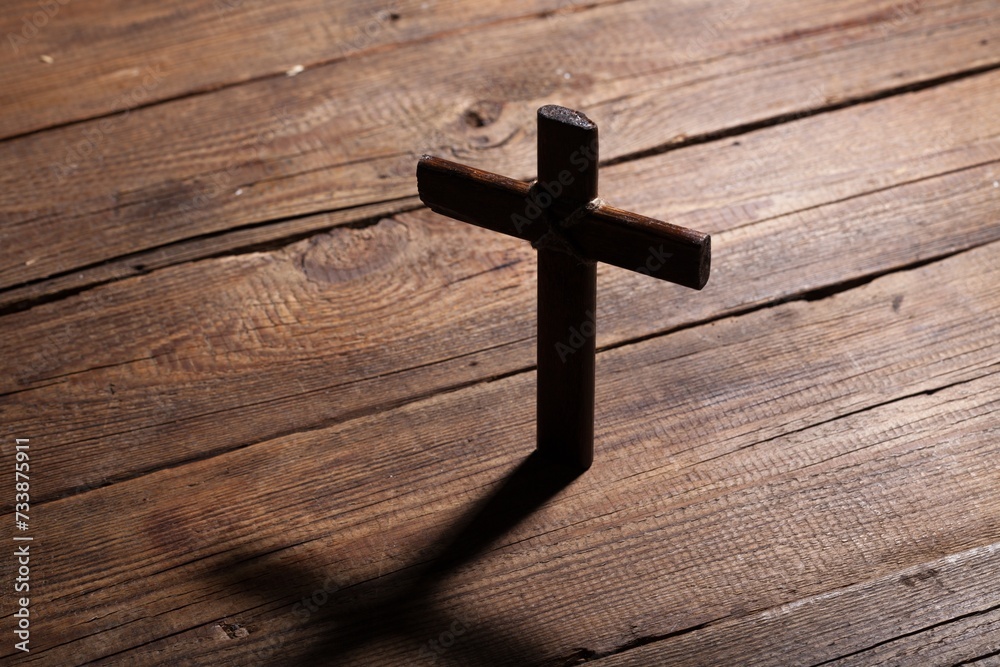 Christian wooden cross on wooden table background