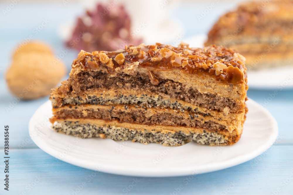 Walnut and hazelnut cake with caramel on blue wooden. side view, copy space, selective focus. Walnut and hazelnut cake with caramel on blue wooden. side view, copy space, selective focus.