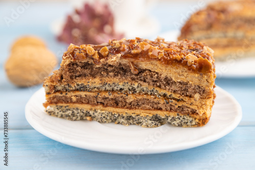 Walnut and hazelnut cake with caramel on blue wooden. side view, copy space, selective focus.
