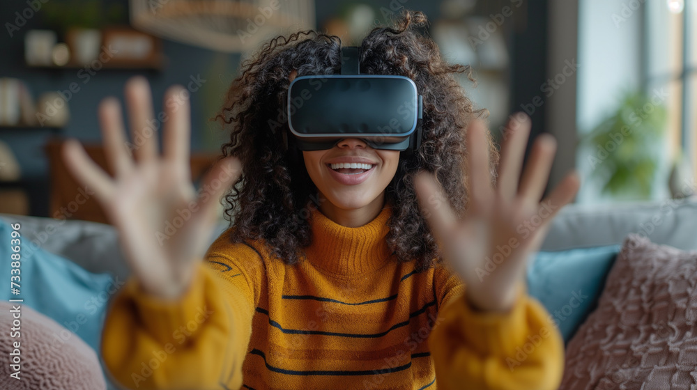 Young woman using virtual or augmented reality headset in home. Woman with VR goggles in living room. Futuristic lifestyle concept. Young woman using virtual or augmented reality headset in home. Woman with VR goggles in living room. Futuristic lifestyle concept.