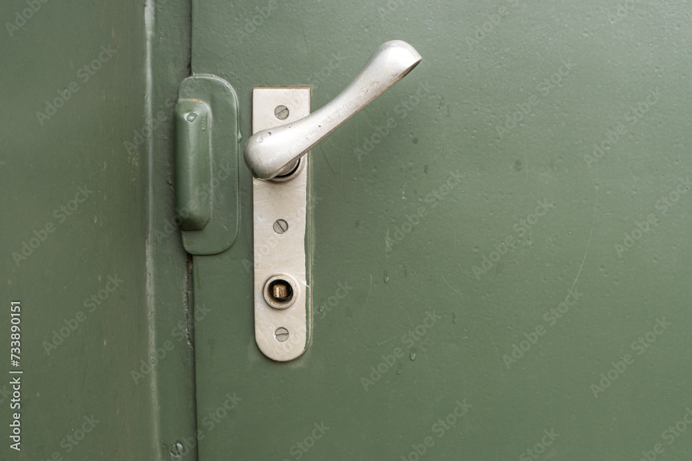 Door handle from a train waggon with green background Door handle from a train waggon with green background