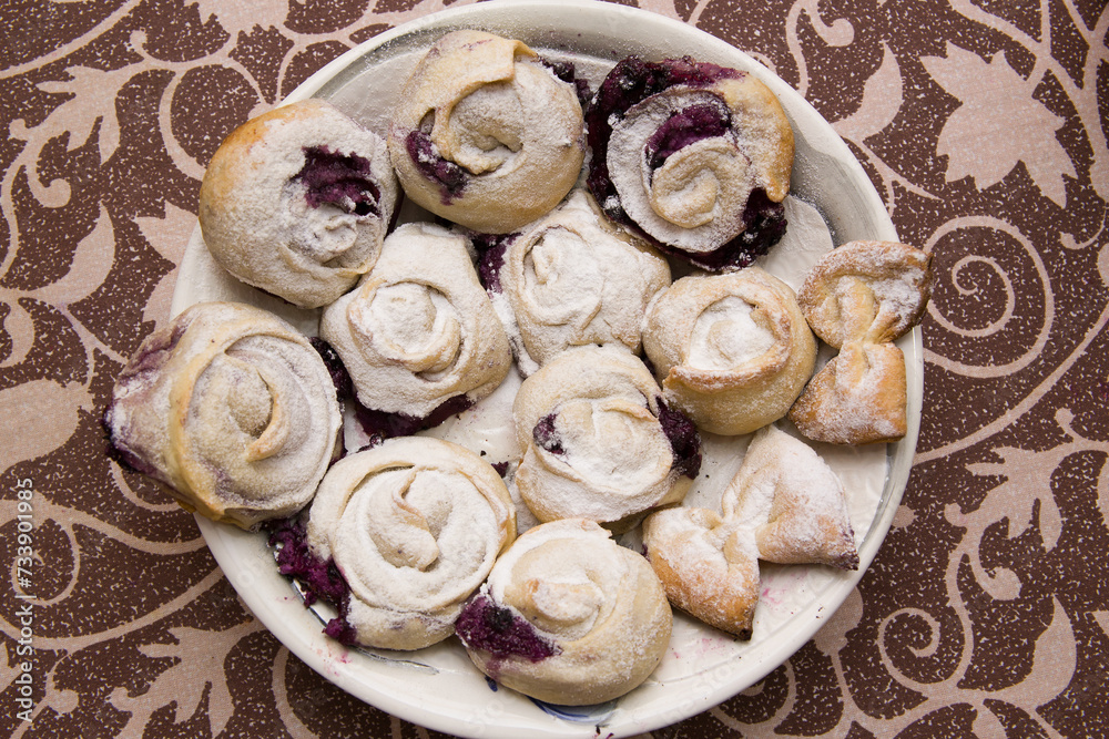 Homemade pastries lie on a large plate.