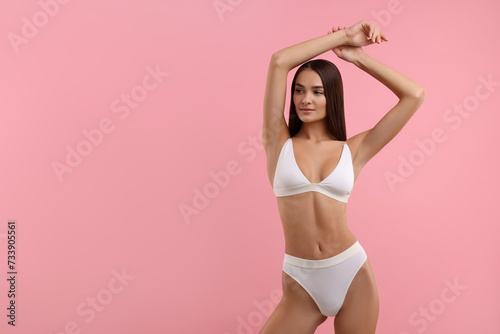 Young woman in stylish white bikini on pink background. Space for text