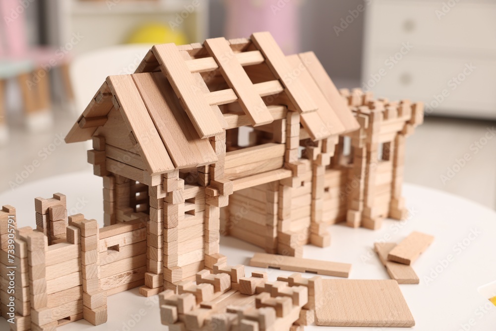 Wooden entry gate and building blocks on white table indoors. Children's toy Wooden entry gate and building blocks on white table indoors. Children's toy