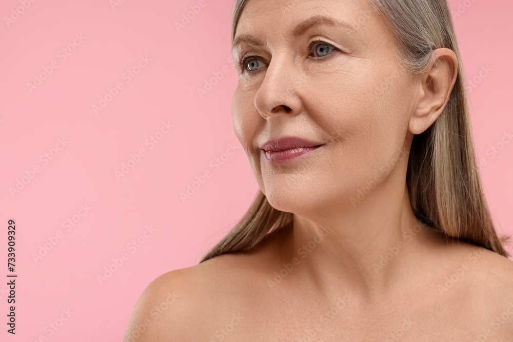 Beautiful woman with healthy skin on pink background, space for text Beautiful woman with healthy skin on pink background, space for text