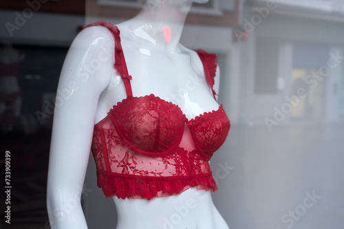 Closeup of red bra on mannequin in a fashion store showroom	