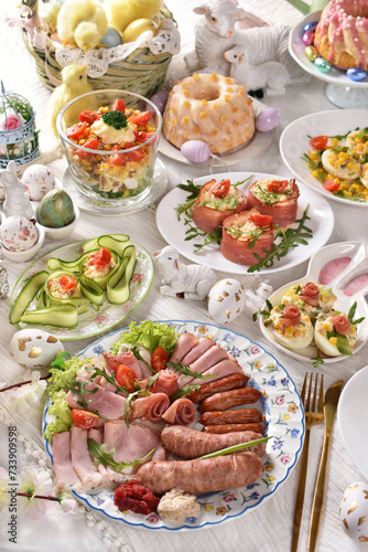 Easter breakfast with traditional sausage and cold cuts, deviled eggs and salads on festive table © teressa