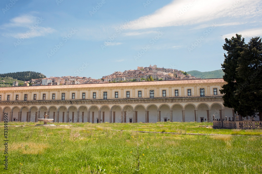Cloister of Padula Charterhouse with the township of Padula in the background. The biggest cloister in the world dated back to 1561. Salerno, Italy.