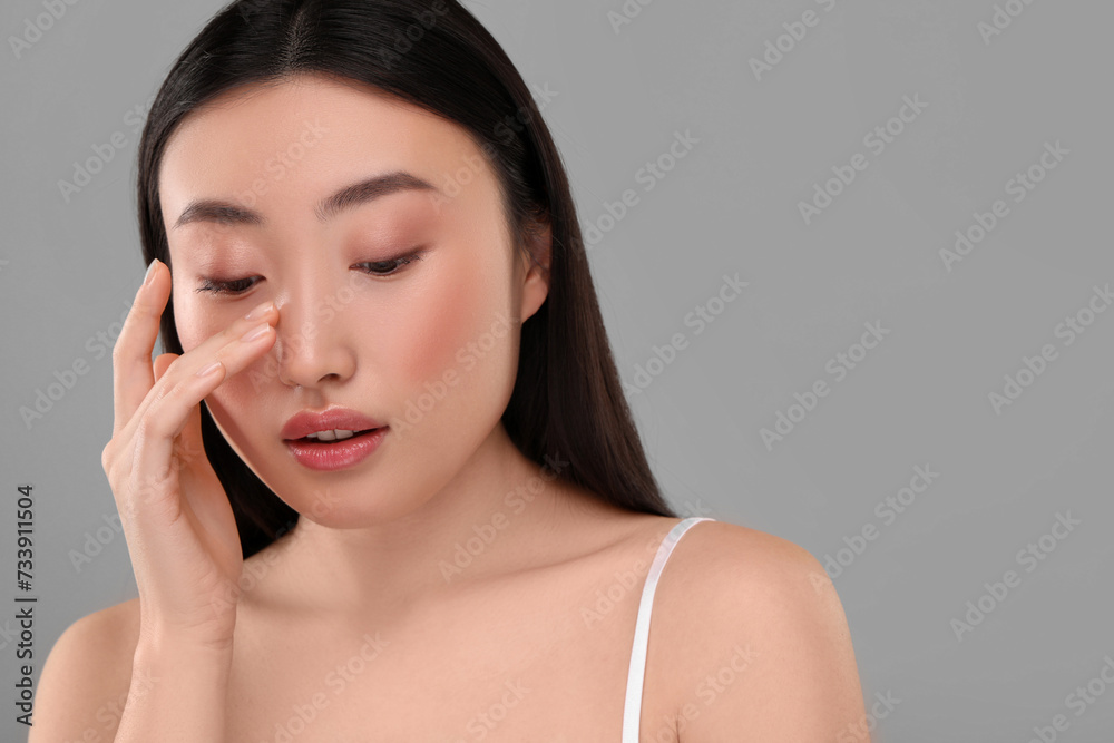 Beautiful woman with healthy skin on gray background, space for text Beautiful woman with healthy skin on gray background, space for text