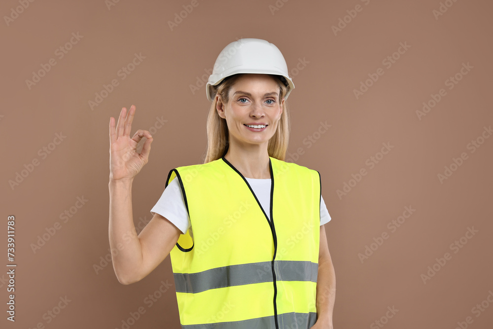 Engineer in hard hat on brown background