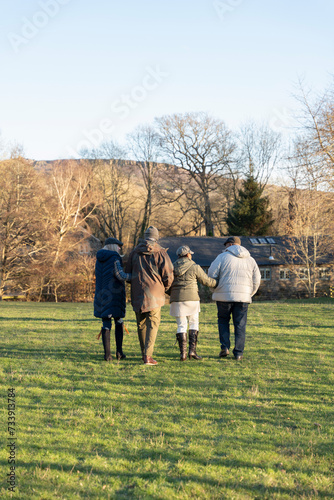 Group of friends walking in meadow © Cultura Creative