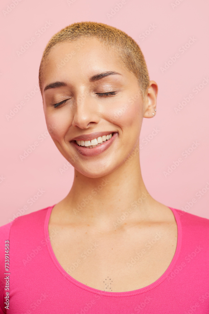 Portrait of smiling woman with short blond hairstyle and closed eyes Portrait of smiling woman with short blond hairstyle and closed eyes