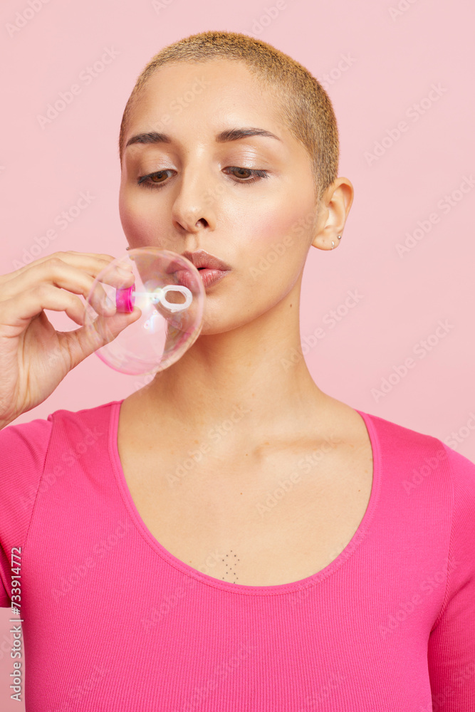 Young blond woman blowing bubbles Young blond woman blowing bubbles