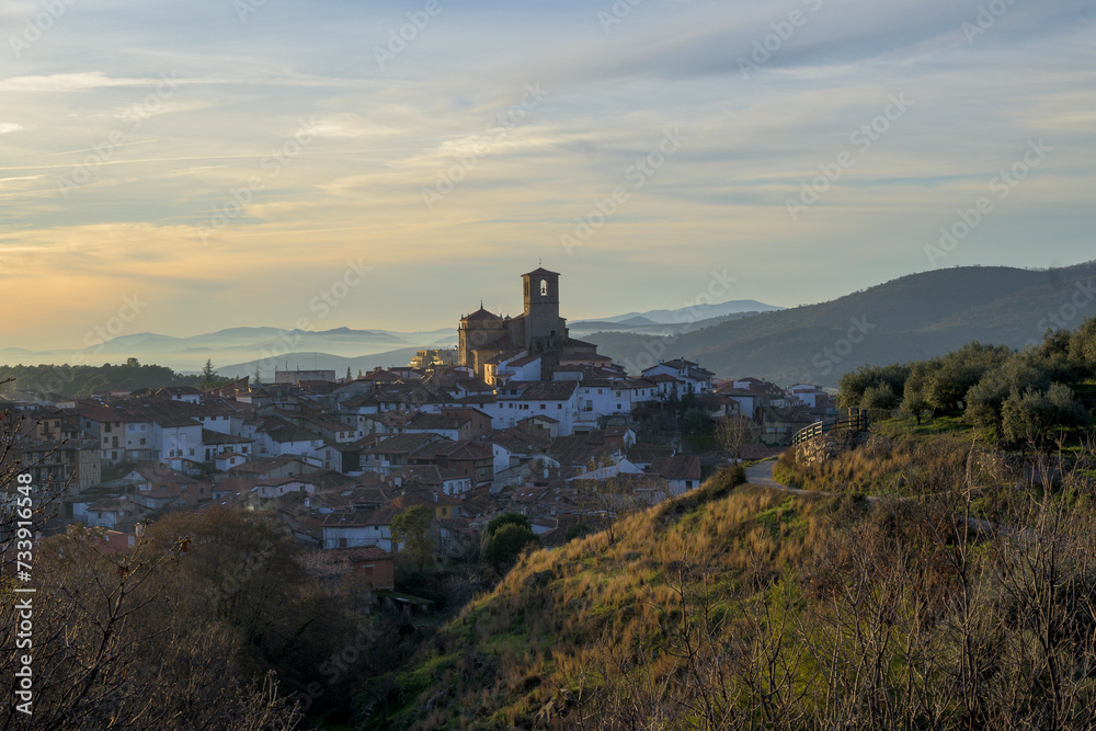 View of the churches of Hervas at sunset in winter with fog in the background horizontally