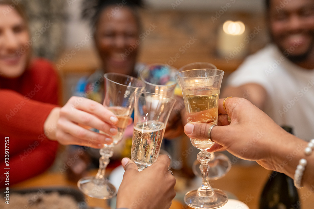 Friends toasting champagne at dinner table 