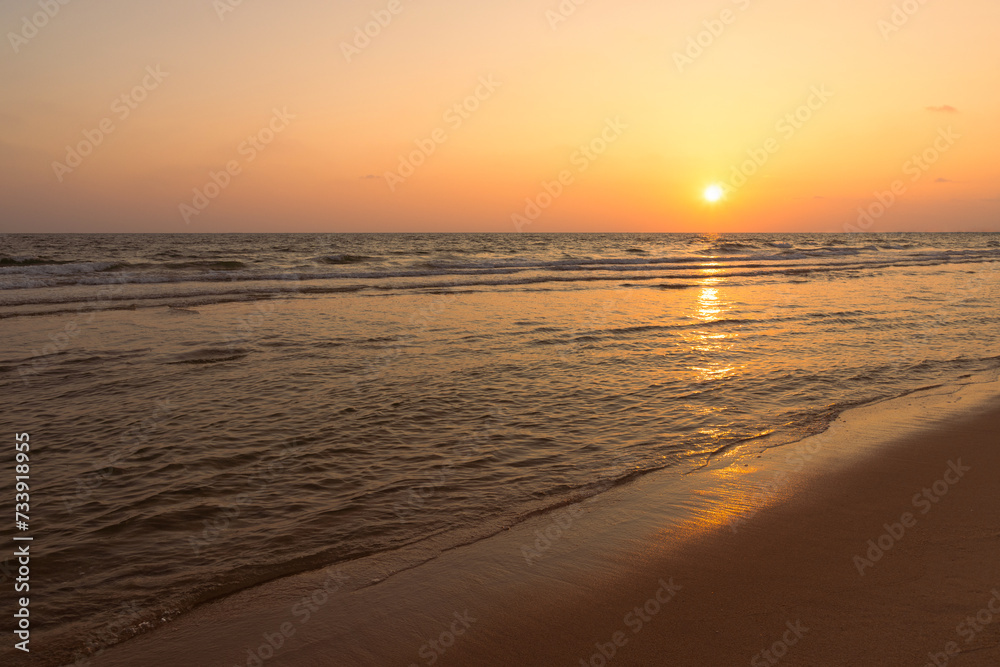 Sunset over the beachy sea with a beautiful orange-red twilight, and reflections in the water. Sea beach with sunrise or sunset, seascape, Landscape